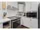 Close up of the modern kitchen featuring stainless steel appliances and plenty of cabinet space at 1001 Helms Pl, Raleigh, NC 27610