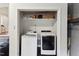 Convenient laundry closet featuring modern, stacked washer and dryer for efficient space saving at 1001 Helms Pl, Raleigh, NC 27610