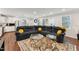 Spacious living room featuring a large sectional sofa, patterned rug, and natural light at 1001 Helms Pl, Raleigh, NC 27610
