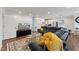 Comfortable living room with a large sectional sofa, patterned rug, and modern entertainment center at 1001 Helms Pl, Raleigh, NC 27610