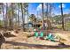 Enjoy this backyard space with a firepit area and adirondack chairs along with a tool shed and deck space at 104 Amberhill Ct, Garner, NC 27529
