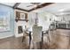 Dining area features hardwood floors, a fireplace, and adjacent white cabinets providing warmth and space at 104 Amberhill Ct, Garner, NC 27529