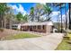 Brick home boasts a well-maintained lawn, complemented by a paved driveway leading to the side of the residence at 104 Amberhill Ct, Garner, NC 27529