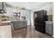 Bright kitchen featuring stainless steel appliances and gray cabinets, and dark wooden floors at 104 Amberhill Ct, Garner, NC 27529