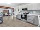 Open kitchen features stainless appliances, tile backsplash, and flows into the dining area at 104 Amberhill Ct, Garner, NC 27529