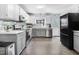 Updated kitchen with sleek appliances, gray cabinets, white upper cabinets, and stylish backsplash at 104 Amberhill Ct, Garner, NC 27529