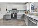 Bright kitchen showcasing stainless steel appliances, tiled backsplash, and wood-look flooring at 104 Amberhill Ct, Garner, NC 27529