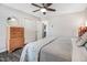 Comfortable bedroom featuring a ceiling fan, hardwood floors, and a double door closet at 104 Amberhill Ct, Garner, NC 27529