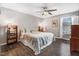 Cozy bedroom with hardwood floors, a ceiling fan, and natural light from the window at 104 Amberhill Ct, Garner, NC 27529