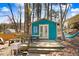 A backyard tool shed with a small deck is the perfect place for a hobby area, and features a hammock and seating at 104 Amberhill Ct, Garner, NC 27529