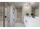 Bathroom with double vanity, a walk-in shower, and modern light fixtures at 1065 Hardin Hill Ln, Knightdale, NC 27545