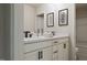 Modern bathroom featuring double vanity, quartz countertops, black fixtures, and framed art at 1065 Hardin Hill Ln, Knightdale, NC 27545