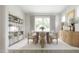 Bright dining area features a modern light fixture, large window, and stylish decor at 1065 Hardin Hill Ln, Knightdale, NC 27545