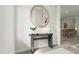 A modern entryway with a round mirror, sleek console table, and stylish decorations at 1065 Hardin Hill Ln, Knightdale, NC 27545