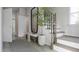 Inviting entryway features a bench, a mirror, stairs with a black railing, and light wood flooring at 1065 Hardin Hill Ln, Knightdale, NC 27545