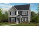 Charming two-story home with a combination of gray siding and board and batten at 1065 Hardin Hill Ln, Knightdale, NC 27545
