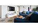 Living room featuring a comfortable blue sofa, modern decor, and bright natural light at 1065 Hardin Hill Ln, Knightdale, NC 27545