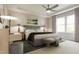 A beautifully staged main bedroom has a plush bed, art, ceiling fan, and stylish decor at 1065 Hardin Hill Ln, Knightdale, NC 27545