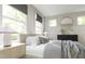 Bright main bedroom with a window, neutral color palette, and black dresser at 1065 Hardin Hill Ln, Knightdale, NC 27545