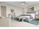 A beautifully staged main bedroom has a plush bed, art, ceiling fan, and stylish decor at 1065 Hardin Hill Ln, Knightdale, NC 27545
