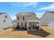 Exterior view of the backyard featuring a covered patio and seating area at 117 Highland Forest Dr, Fuquay Varina, NC 27526