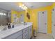 Bright bathroom featuring a double sink vanity, quartz countertops and tiled shower at 117 Highland Forest Dr, Fuquay Varina, NC 27526