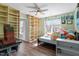Cozy bedroom featuring wood floors, a ceiling fan, and natural light at 117 Highland Forest Dr, Fuquay Varina, NC 27526