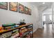 Hallway features a wooden shelving unit filled with board games and modern art pieces at 117 Highland Forest Dr, Fuquay Varina, NC 27526