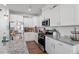 Modern kitchen features stainless appliances, a granite countertop, and white cabinets at 117 Highland Forest Dr, Fuquay Varina, NC 27526