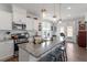 Kitchen featuring granite counters, stainless steel appliances, and an island with seating at 117 Highland Forest Dr, Fuquay Varina, NC 27526