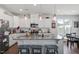 Open kitchen with island seating featuring granite countertops and stainless steel appliances at 117 Highland Forest Dr, Fuquay Varina, NC 27526