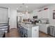 Bright kitchen boasts granite counters, an island with seating, and modern appliances at 117 Highland Forest Dr, Fuquay Varina, NC 27526