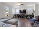 Living room featuring multiple windows, wood flooring, stylish furniture, and backyard views at 117 Highland Forest Dr, Fuquay Varina, NC 27526