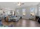 Living room with natural light and a comfortable sectional sofa with backyard views at 117 Highland Forest Dr, Fuquay Varina, NC 27526