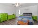 Bedroom with stylish decor featuring wood-look floors, and ample closet space at 117 Highland Forest Dr, Fuquay Varina, NC 27526