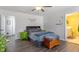 Bedroom features ceiling fan, wood-look flooring, neutral wall paint and ample natural light at 117 Highland Forest Dr, Fuquay Varina, NC 27526
