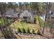 Aerial view of the house with a fenced backyard and mature trees at 119 November Dr, Durham, NC 27712