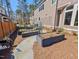 Stone pathway leads through the backyard with the raised garden beds and mature plants at 119 November Dr, Durham, NC 27712