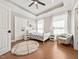Bedroom with hardwood floors, large windows, and a cozy armchair at 119 November Dr, Durham, NC 27712
