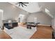 This bonus room features wood floors, a ceiling fan, bar, and other ammenities for games and recreation at 119 November Dr, Durham, NC 27712