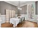 Formal dining room with wood floors, neutral walls, a modern light fixture, and seating for four at 119 November Dr, Durham, NC 27712