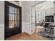 Elegant entryway featuring wood floors, a glass paned door, and a view into the home office at 119 November Dr, Durham, NC 27712