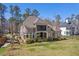 An exterior side angle shot showcases the lawn and meticulously landscaped backyard of this stylish house at 119 November Dr, Durham, NC 27712