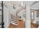 Grand foyer featuring a curved staircase, wood floors, and elegant decor at 119 November Dr, Durham, NC 27712