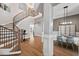 Open concept foyer with views to the formal dining and a curved staircase with wood and iron accents at 119 November Dr, Durham, NC 27712