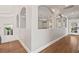 Bright hallway featuring hardwood floors, archways, and built-in shelving with modern decor at 119 November Dr, Durham, NC 27712
