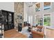 Open-concept living area with soaring ceilings, stone fireplace and plentiful natural light at 119 November Dr, Durham, NC 27712