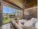 Comfortable outdoor seating on a screened-in porch overlooking the backyard at 119 November Dr, Durham, NC 27712