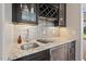 Wet bar featuring granite counters, wine fridge, and glass storage at 119 November Dr, Durham, NC 27712