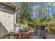Serene back deck with striped seating, a bistro table, and a peaceful view of the landscaped surroundings at 131 Long Shadow Ln, Cary, NC 27518